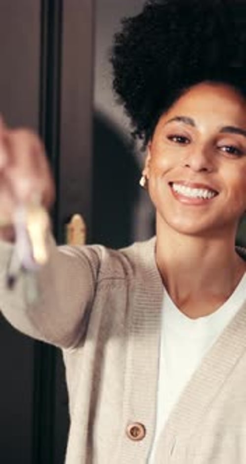 Face, woman and smile with keys at new house for real estate, property investment