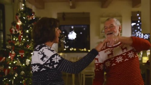 Senior couple dancing together at Christmas time