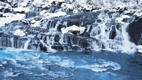Snowy Waterfall with Pure Blue Glacier Water in Iceland Frozen Winter Landscape Magical Outdoor