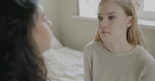 Unhappy Young Woman Talking to Friend Sharing Bad News Getting Support Sitting in Bed at Home