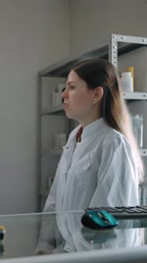 Vertical of Two Confident Caucasian Pharmacists Talking About Medicine Indoor of Pharmacy