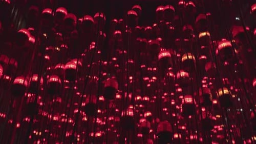 Red lamps blinking all together in lines with a view from a lower angle at night