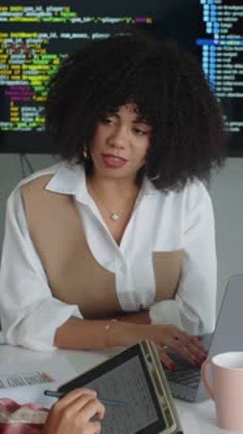 Woman Typing on Laptop in Modern Office