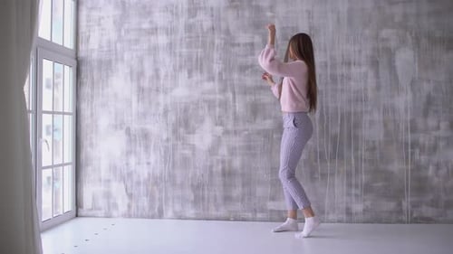 Young Woman Dancing and Posing in an Empty Room