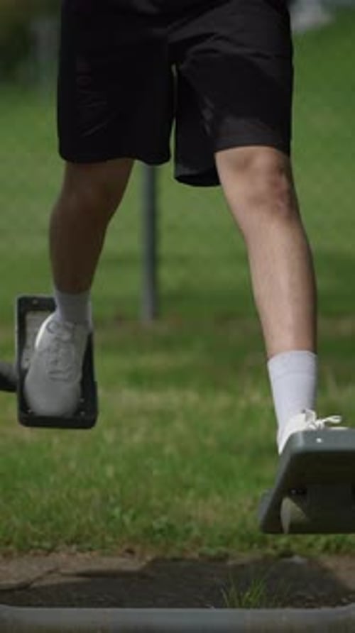 Young Adult Using Outdoor Fitness Equipment