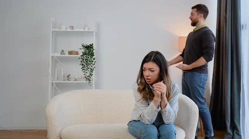 Couple Arguing in Bright Living Room