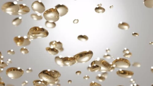 Abstract Golden Liquid Drops Floating Upward Background