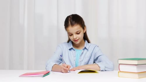 Young Girl Writing at Desk with Books and Notebook