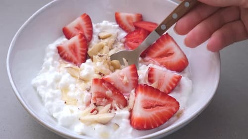 Cottage cheese with honey, strawberry and nuts.