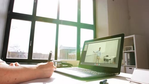 Student Attending Online Class and Taking Notes