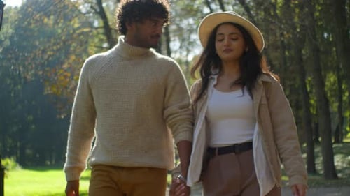 Happy Multiethnic Couple in Love Walking Talking Holding Hands in Park Romantic Date in Nature