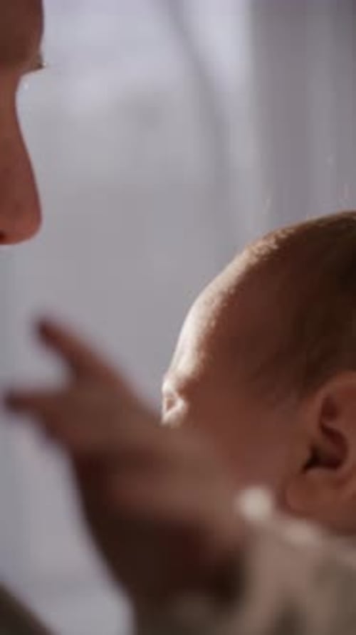 Close Up of Father Holding Crying Baby in His Arms