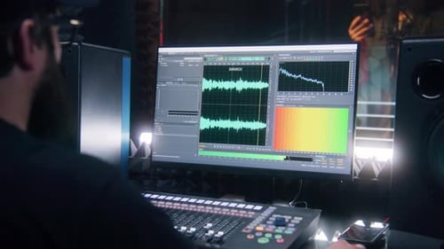 Audio Engineer Mixing Music in Recording Studio
