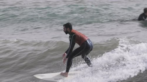 Male Surfer Riding a Wave