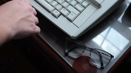 Person Typing on Retro Computer Keyboard Close Up