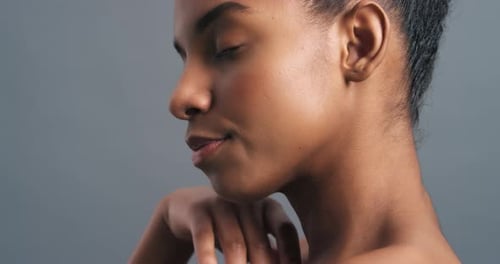 Elegant Woman Touches Face in Studio Smiling