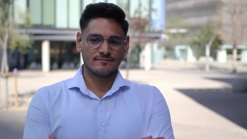 Man Smiling Confidently Outdoors in the City