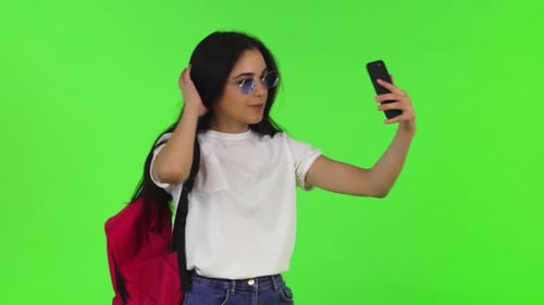 Young Woman Taking Selfie on Green Screen