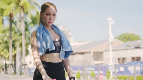 Woman Lifting Dumbbell for Exercise on Sunny Day