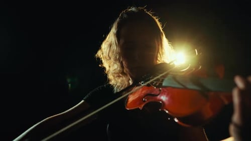Violinist Playing in the Dark with Bright Light