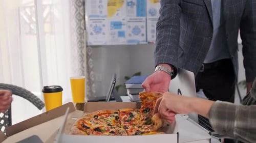 Coworkers Eating Pizza Together in Office