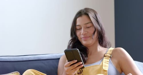 Young Woman Using Smartphone and Credit Card for Online Shopping at Home