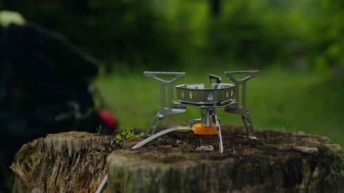 Camping Stove on Tree Stump With Pot
