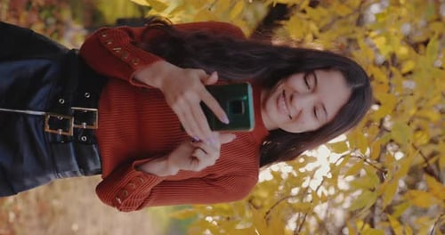 Woman Using Phone Vertical Video Autumn Day