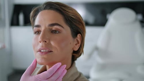 Unknown Beautician Checking Skin Health Attractive Woman Sitting In Luxury Cosmetology Clinic Clo...