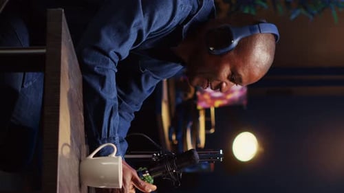 Vertical Video Influencer Unboxing Tech Product for Review Recording Podcast with Guest in Studio