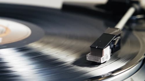 Red Neon Light Glowing On Spinning Vinyl Turntable Retro Analog Music Close Up