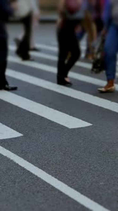 Anonymous People Walking Across City Street Zebra Crossing