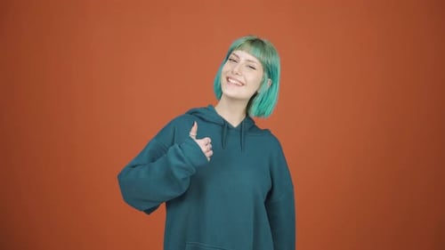 Smiling Woman Gives Thumbs-Up, OK Hand Gesture