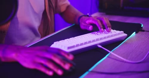 Person Working at Computer Typing on Keyboard