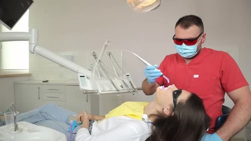 Dentist Checks Teeth in Dental Office for Health Care