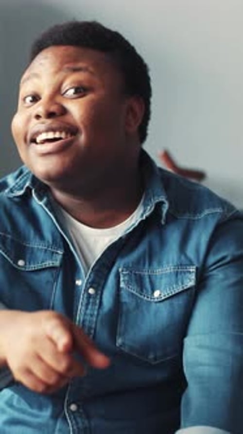 Man Points at Camera with Friendly Smile