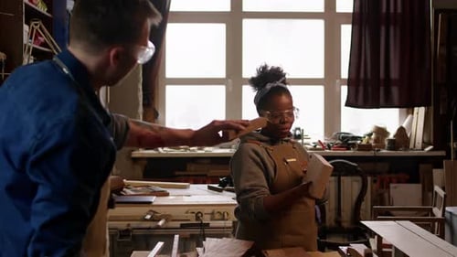Multiethnic Carpenters Doing Woodwork in Workshop