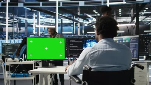 Data Center Worker with Paraplegia Using Node Trees on Green Screen PC