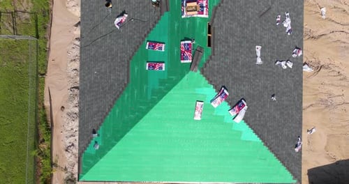 Aerial View of Roof Repair Progress in Suburban Area