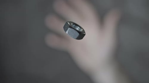 Metal Nut Spinning in Place Close Up
