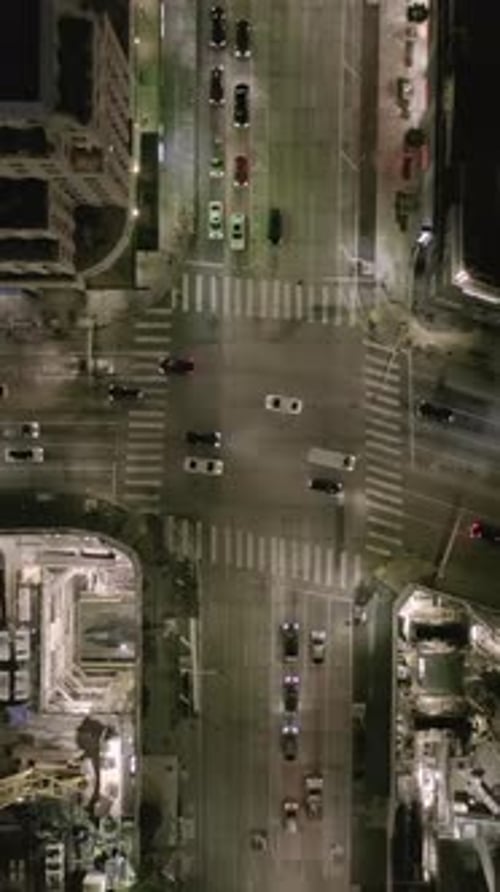 AERIAL Overhead View on Intersection Street with Big Construction Site and Holes in Ground at Night