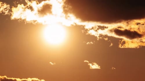 Sunset with Golden Clouds and Bright Sun
