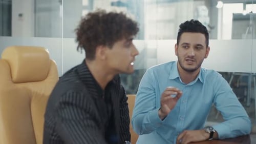Business Partners are Discussing Use Computer Speak in a Modern Office Shot on RED Epic Camera