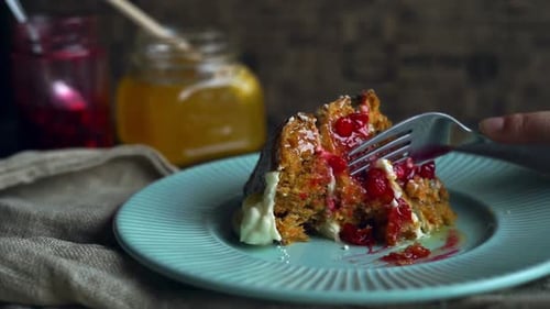 Fork cuts delicious slice of berry cake