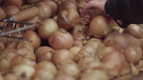 Picking an onion from a pile of onions
