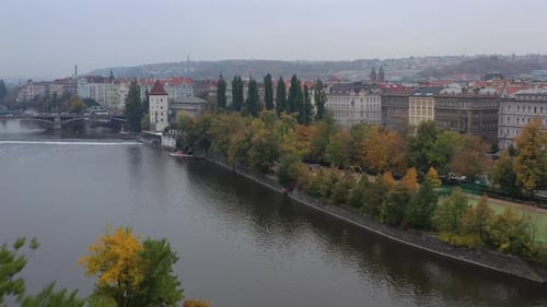 Aerial cinematic view of Prague, Czech Republic, Prague cityscape showing medieval bridges and boats
