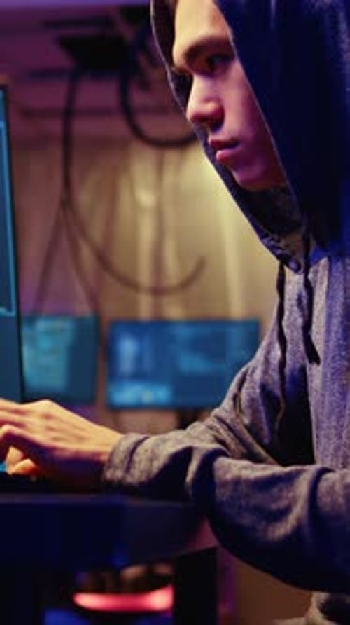 Vertical Video Hacker at Computer Developing Spyware