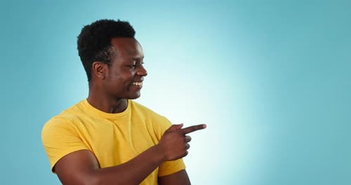 Happy man, face and pointing to choice in studio of announcement, sales deal