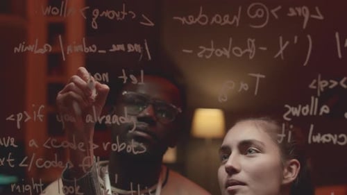 Female Programmer Writing Computer Command on Glass Board