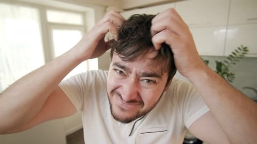 Man Scratching Head Close Up Indoors